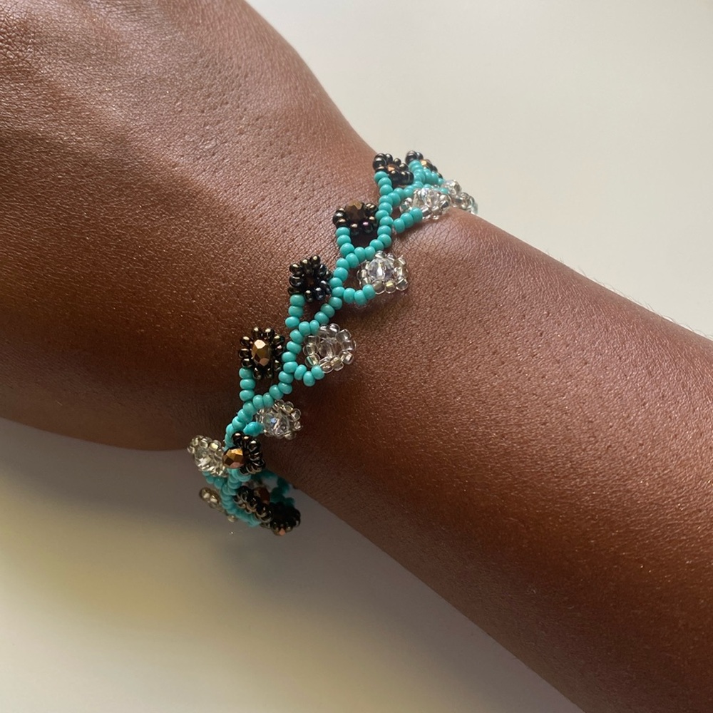 Beaded bracelet with flower-like design, turquoise, white, and brown!